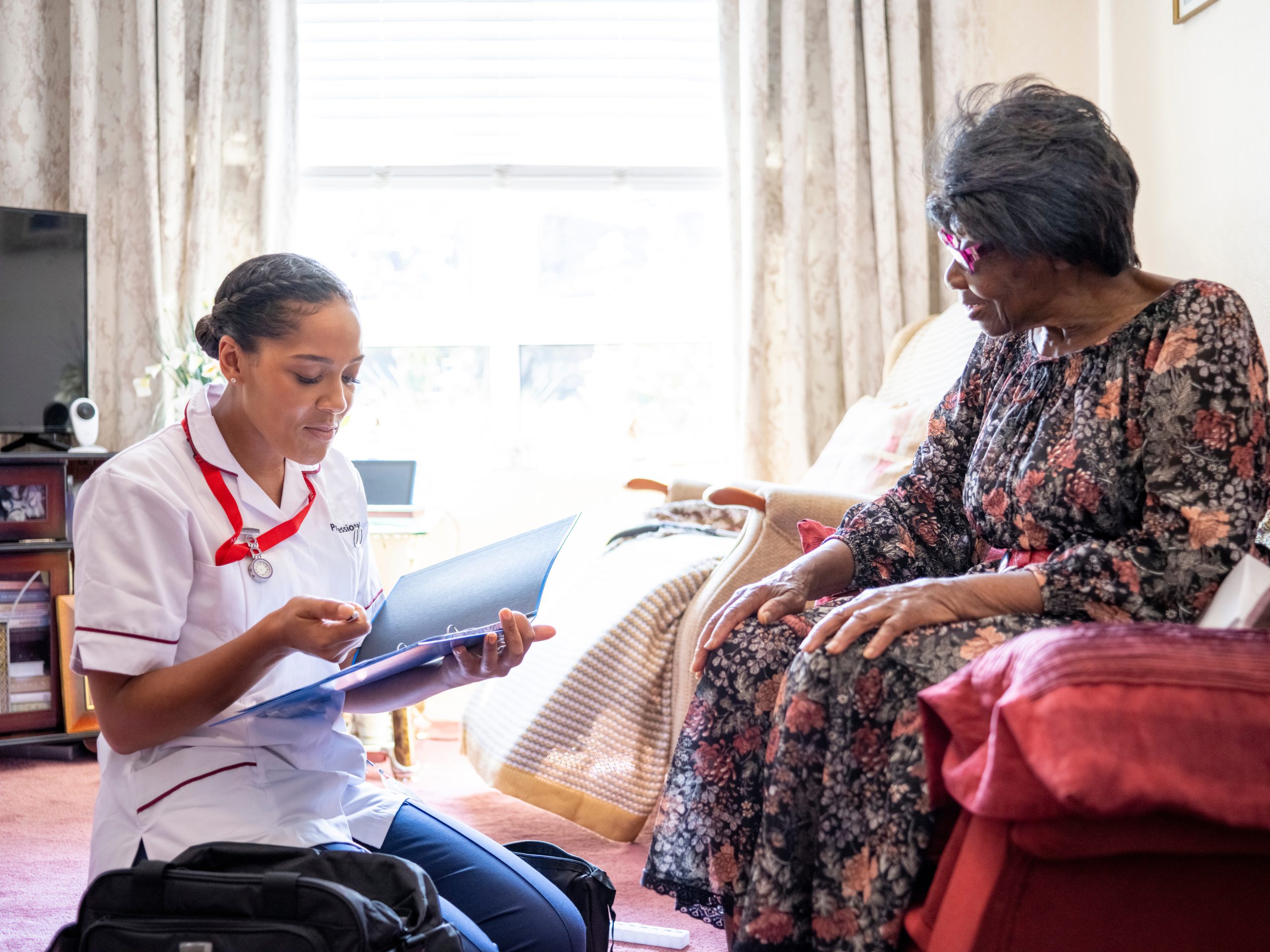 Elderly woman talking with nurse